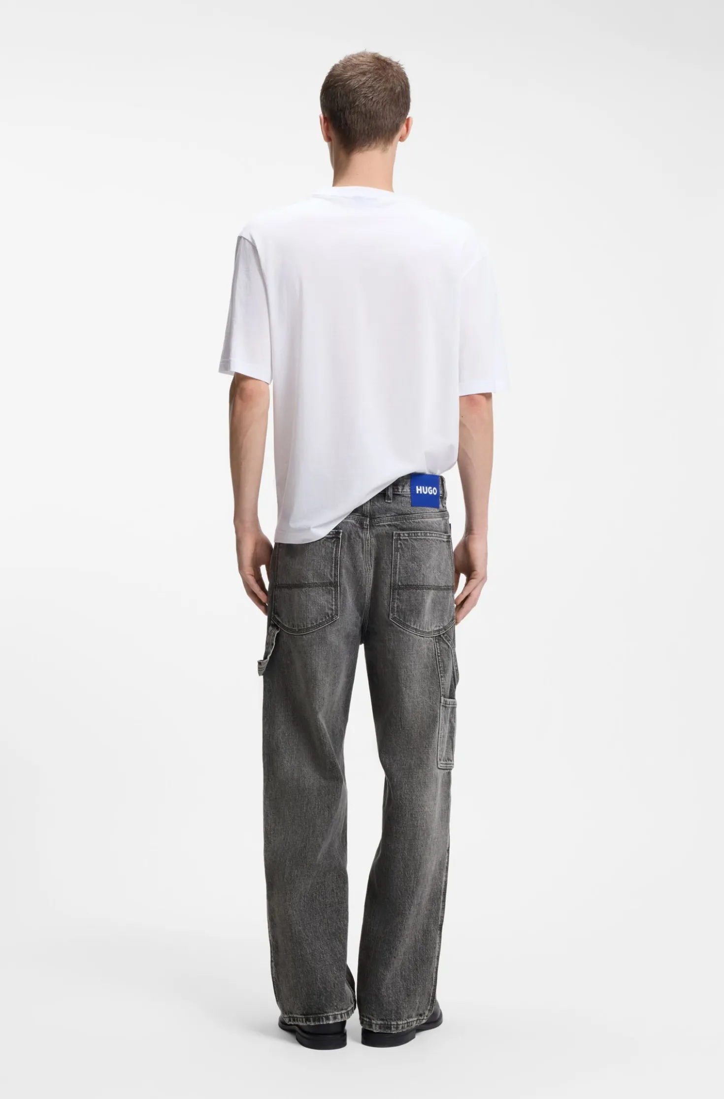 Baggy-fit black jeans with carpenter details
