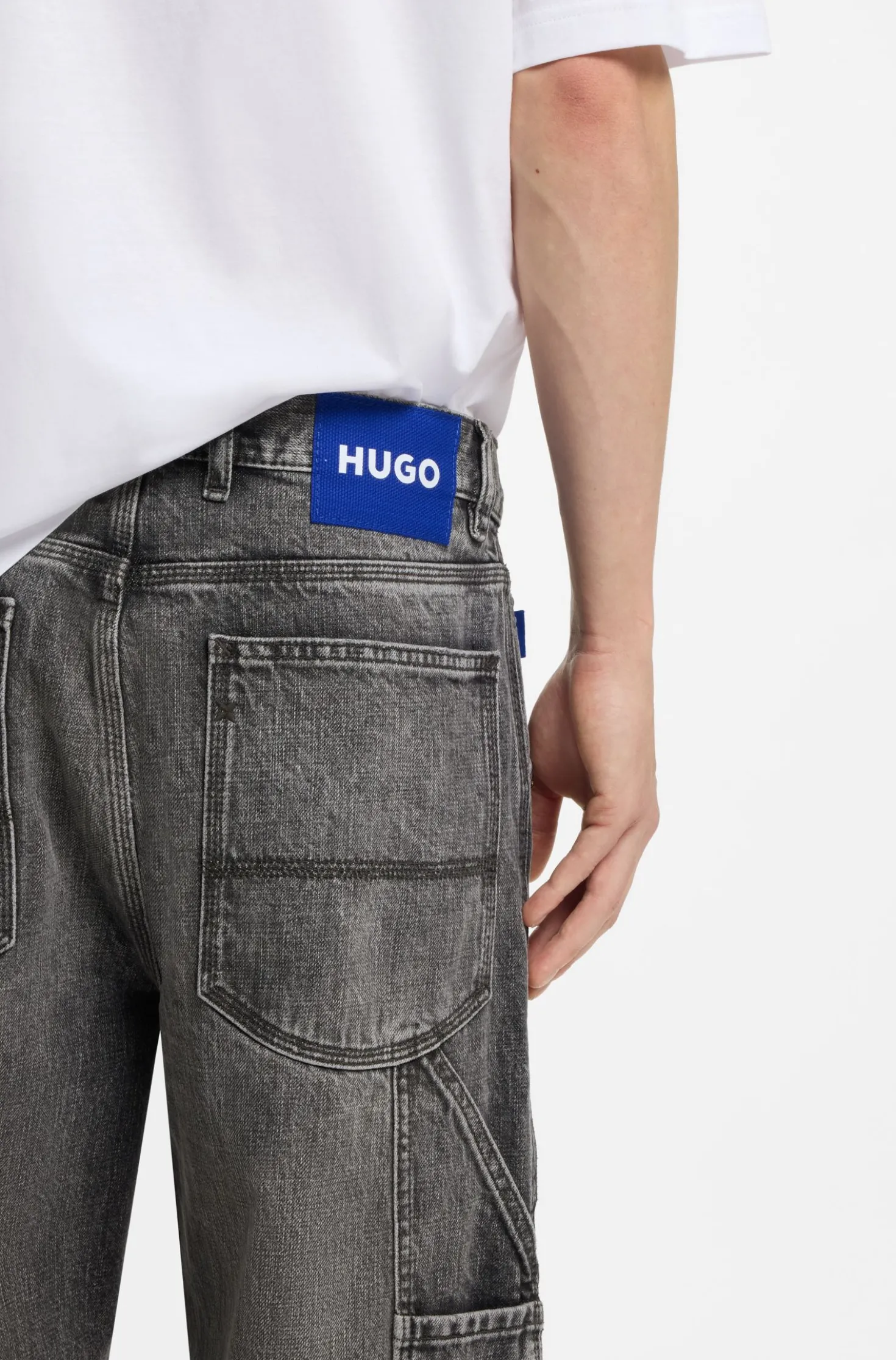 Baggy-fit black jeans with carpenter details