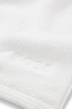 Cotton bath mat with contrast embroidered logo