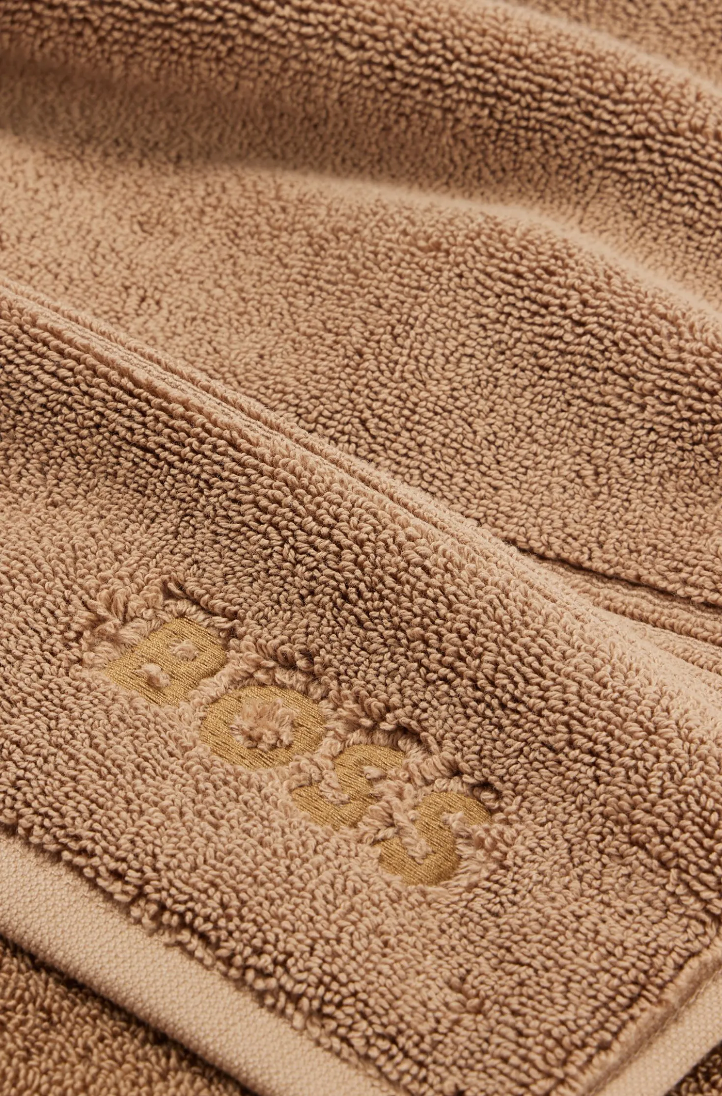 Cotton bath mat with embroidered logo