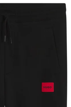 Cotton-terry tracksuit bottoms with red logo label