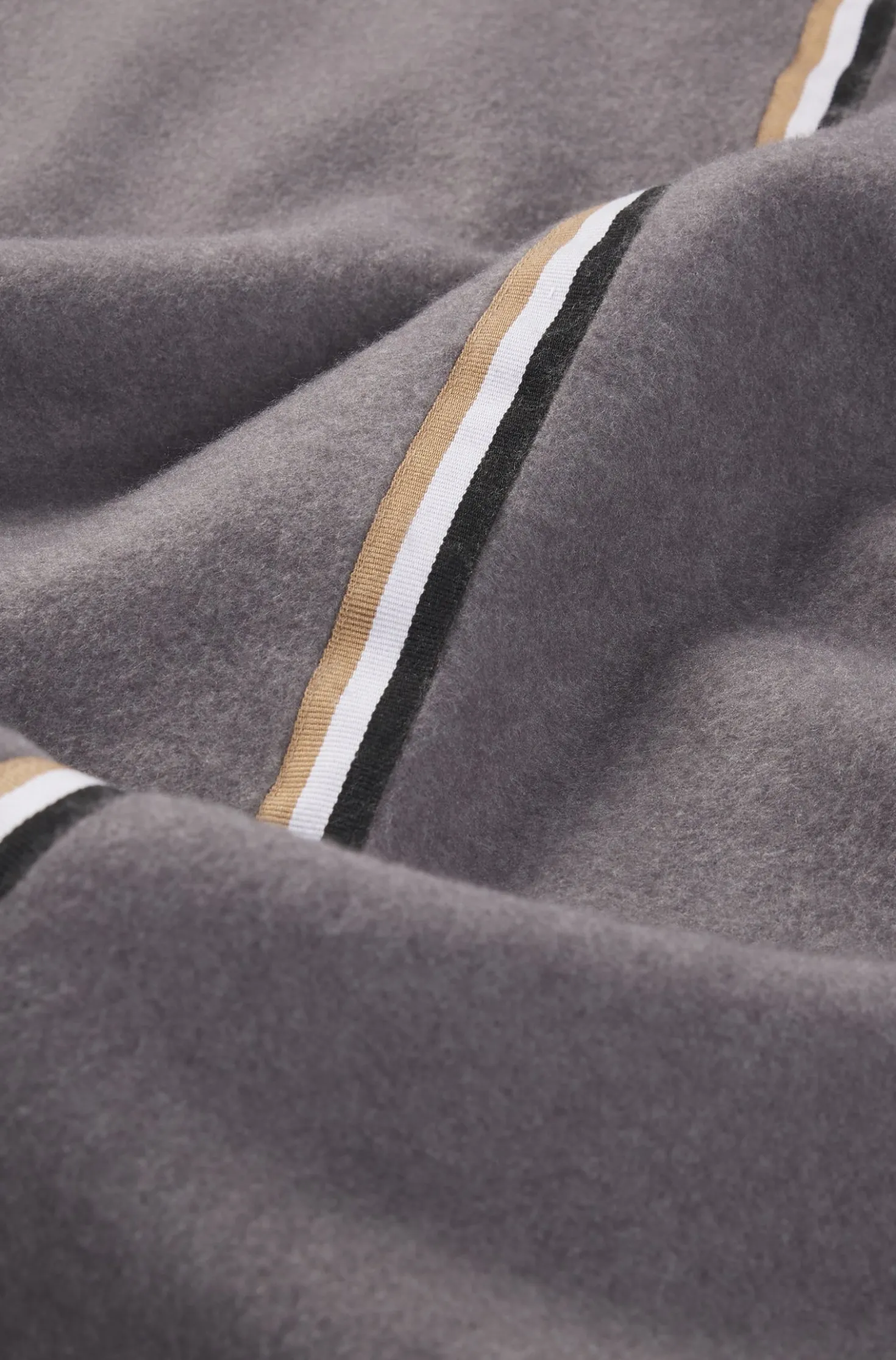 Fleece throw with signature-stripe ribbon