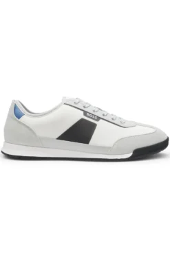 Mixed-material trainers with ridged outsole