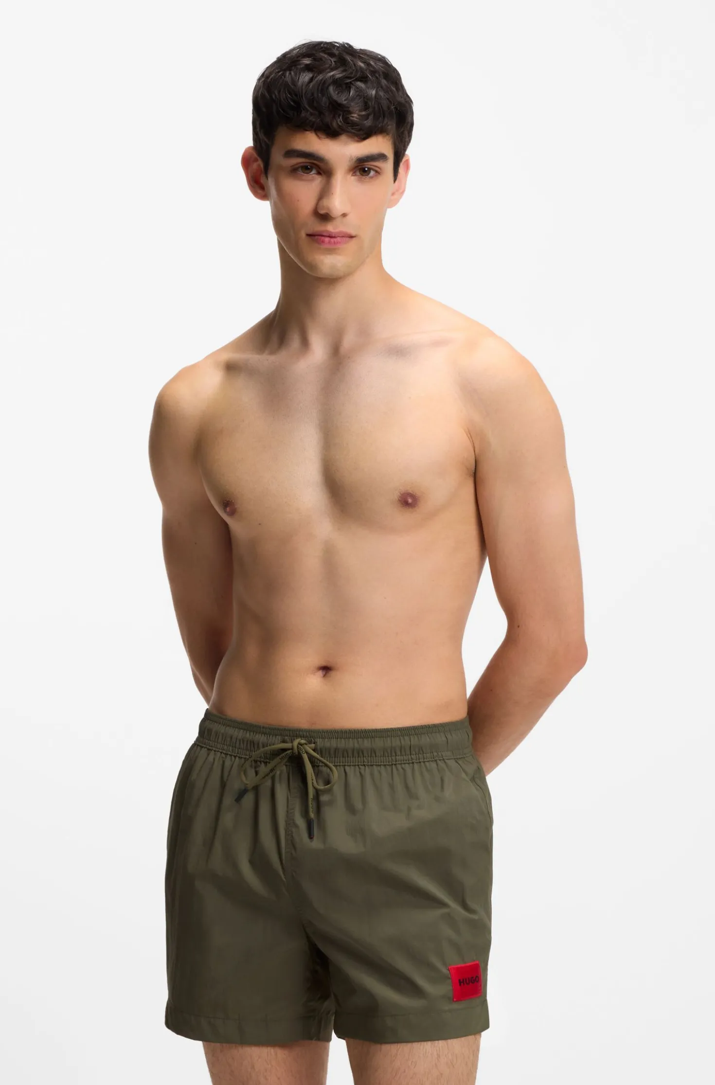 Quick-drying swim shorts with red logo label
