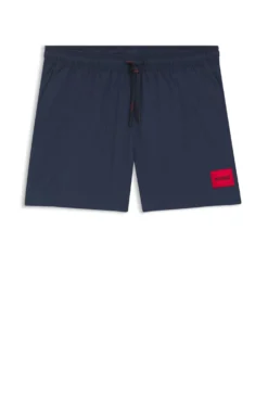Quick-drying swim shorts with red logo label