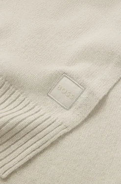 Ribbed-hem plain-knit scarf with woven logo badge