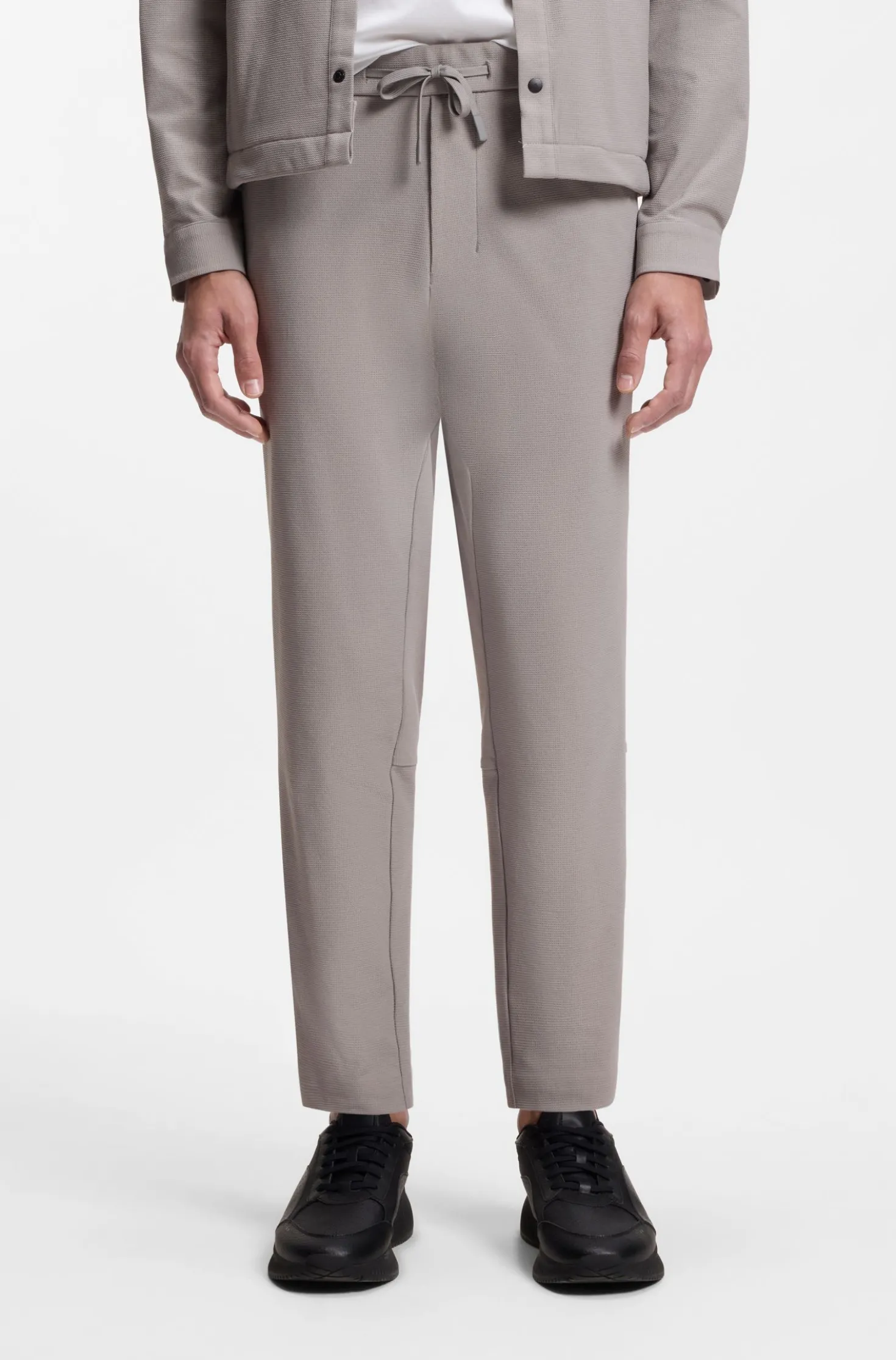 Tapered-fit trousers in waffle-structured stretch fabric