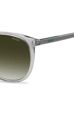 Transparent-grey sunglasses with green logo