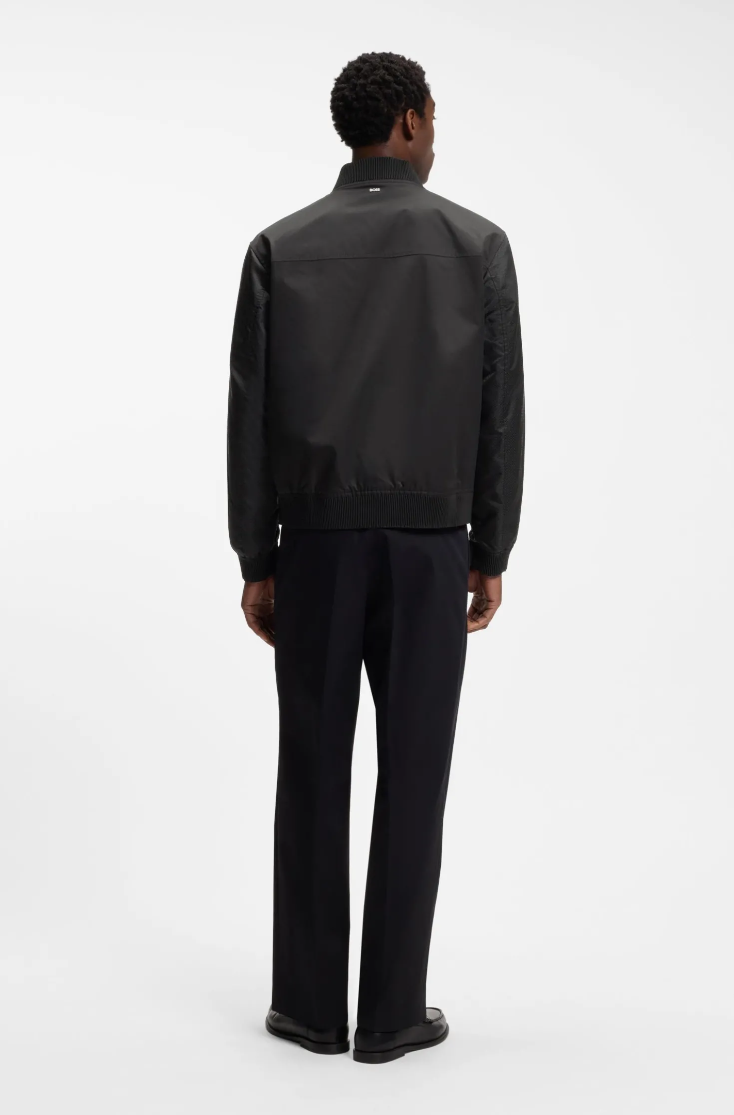 Water-repellent jacket with monogram-pattern sleeves